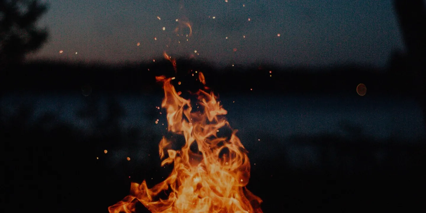 Campfire flames at dusk