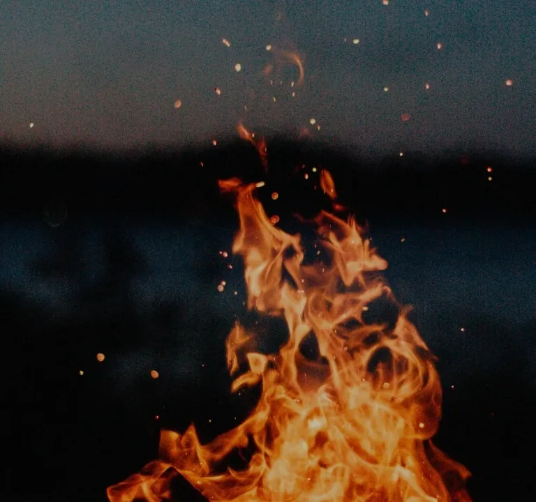 Campfire flames at dusk